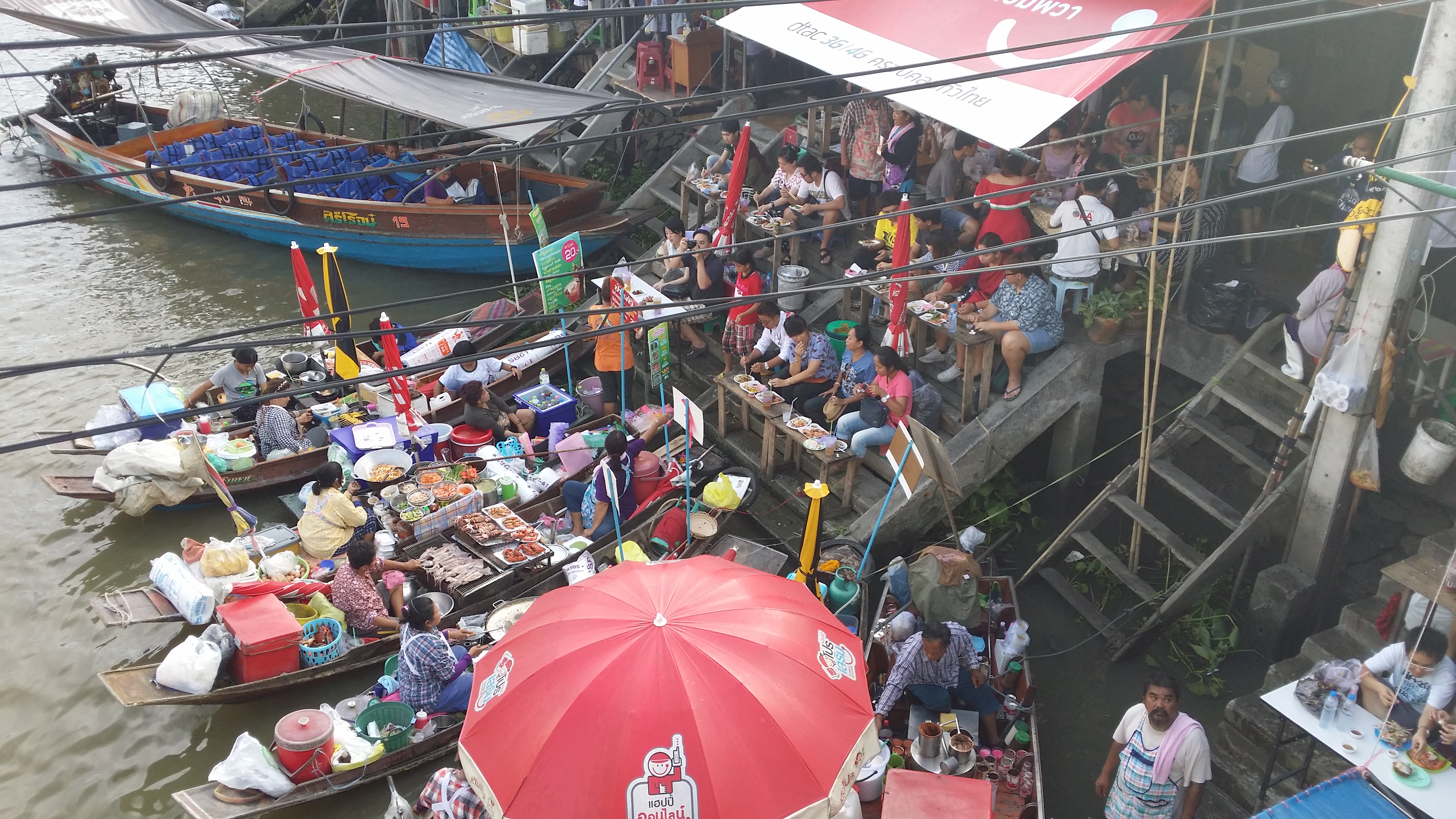 Amphawa floating Markets located on the Mae Klong River is one of the most popular floating markets near Bangkok. Damnoen Saduak still trumps Amphawa for size, but does not match up for authenticity where most of the visitors are Thai's. Amphawa markets are located only 50 km from Bangkok, it is a haven for Thai's wanting to escape Bangkok on the weekends and now days stretches well into the surrounding streets. One of the big drawcards for the markets is of course the opportunity to eat seafood grilled on wooden boats moored around the famous narrow bridge. Tucking into the seafood is a must, with a huge array of prawns, shellfish and squid available from noon until late into the evening. Customers who dine on the seafood can perch themselves on rows of narrow steps leading down to the river below, and your meal will be brought you do directly from the boat it is cooked on. There are many restaurants available along the river, with many featuring balconies allowing you to take in the sights and smells of the bustling market. Expect to be pushed and shoved around as you shop through the market stalls, when this place is busy, walking bodies grind to a halt. You can expect to see all the usual garb in the market stalls, but there will be many foods for sale that you will not find in many other markets. With Thai's naturally having such a sweet tooth, there are a wide array of deserts available that you can snack on all day long. Another must do at the Amphawa Markets is to take the opportunity to jump on a longtail boat and do a tour of the temple that are scattered along the banks of the Mae Klong River. Many opportunities will be available to also move up the Khlongs which is great fun. We went on a 2 hour tour which was booked from one of the counters found near the bridge, it set us back 50thb per person for our 5 temple tour. Make sure the tour you take includes Wat Bang Koong, which if you have come all the way from Bangkok is worth the stop.
